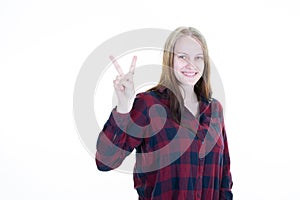 Young woman show hand v two fingers in positive and peace gesture smiling on white background