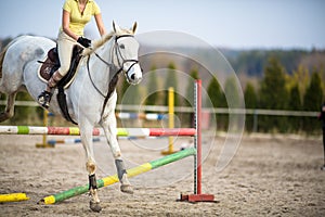 Young woman show jumping