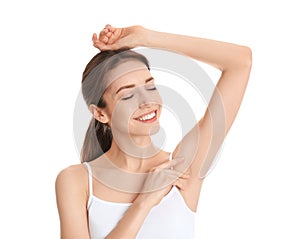 Young woman showing armpit with smooth clean skin on background