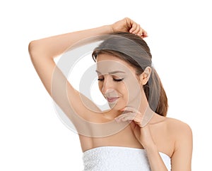 Young woman showing armpit with smooth clean skin on background