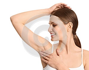 Young woman showing armpit with smooth clean skin on white background