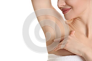 Young woman showing armpit with smooth clean skin on white background, closeup