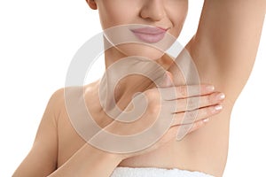 Young woman showing armpit with smooth clean skin on white background, closeup