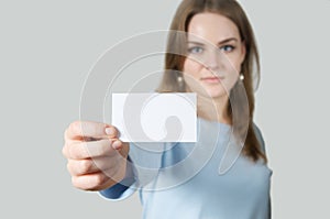 Young woman showing blank business card