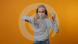 Young woman showing blank gray card, showing thumbs down gesture. 4K video.