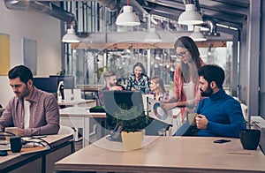 Young woman showing diagrama of growth to her colleague