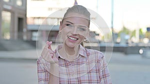 Young Woman showing Heart Shape by Hands Outdoor