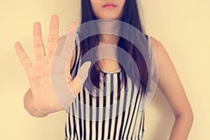 Young woman showing her denial with NO on her hand.