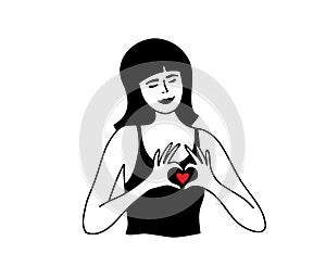 Young woman showing love sign by hands making fingers heart shape