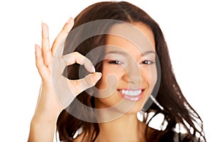 Young woman showing perfect sign.