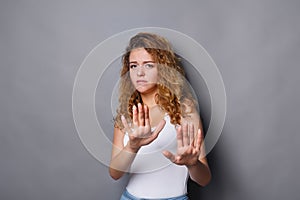 Young woman showing rejection sign