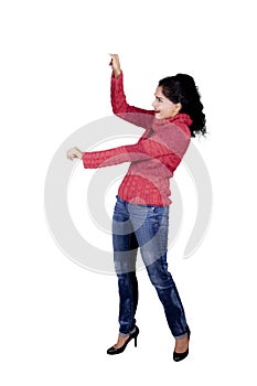 Young woman showing something on studio