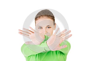 Young woman showing stop sign with both hands