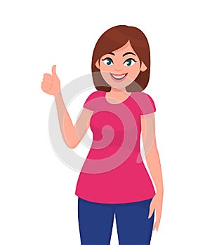 Young woman showing thumps up sign or gesture. Deal, agree, approve, positive, okay, human emotion and body language concept.