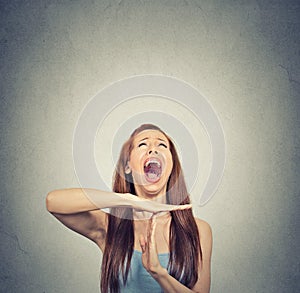 Young woman showing time out hand gesture, frustrated screaming