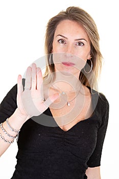 Young woman showing trespass sign stretch hand towards camera looking disappointed saying no demanding turn away reject unpleasant photo