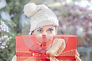 Young woman shows her gift packs inside a Christmas shop photo