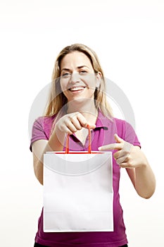 Young woman shows paper shoppings bag