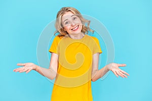 Young woman shrugging shoulders, smile and doing oops gesture