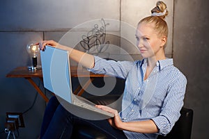 Young woman shutting down laptop