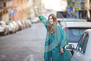 young woman signaling for a taxi