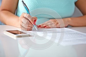 Young woman signs a contract