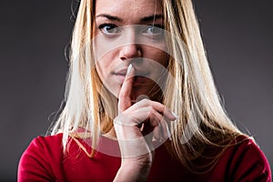 Young Woman with Silence Gesture