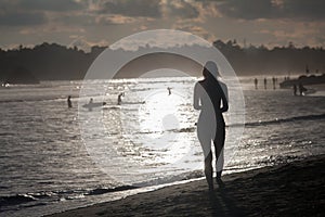 Young woman silhouette on the beach