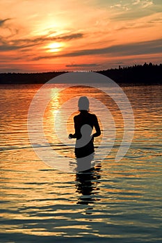 Young woman silhouette at Krasavitsa lake, Zelenogorsk, Russia