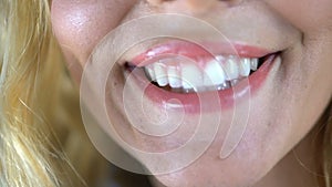 Young woman sincerely smiling, showing her white healthy teeth, dental services