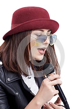 A young woman singing with a microphone