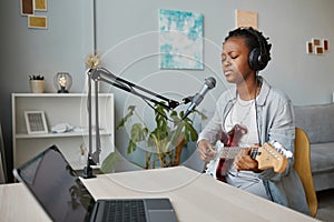 Young Woman Singing to Microphone