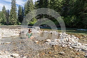 Young woman sits in a natural hot springs in Idaho - Sacajawea H photo