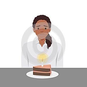 Young woman sits at table with piece cake with candle and suffers from absence of relatives and friends. Unhappy mother celebrates