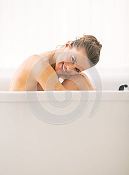 Young woman sitting in bathtub