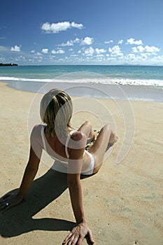 Young woman sitting on the beach