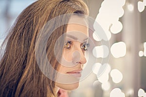 Young woman sitting in beauty salon is posing on the camera