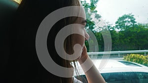 A young woman sitting in the bus and looking in the window