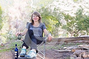 Young woman sitting chair in forest.