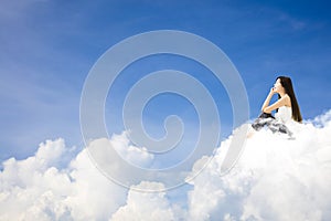 Young woman sitting on cloud and thinking