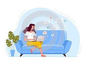 A young woman is sitting on the couch, holding a laptop and texting by email. The concept of remote work