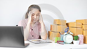 Young woman sitting on a desk is sad or depressed about a sales business