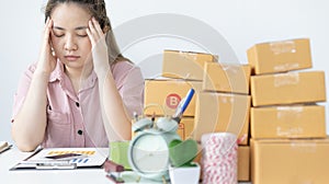 Young woman sitting on a desk is sad or depressed about a sales business