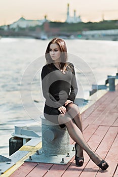 A young woman is sitting on the device for the mooring