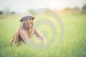 Young woman sitting feel good in grass