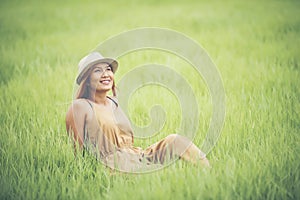 Young woman sitting feel good in grass