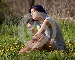 Young Woman Sitting in a Field