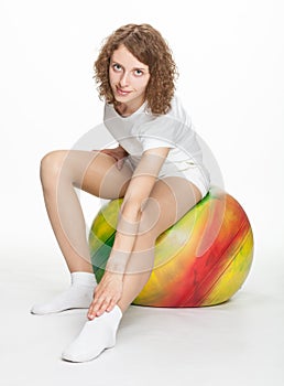 Young woman sitting on a gymnastic ball