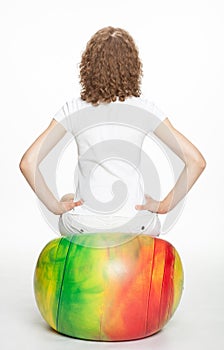 Young woman sitting on a gymnastic ball