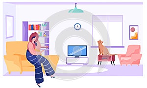 Young woman is sitting with her cat on armchair in livingroom with window, bookcase at home